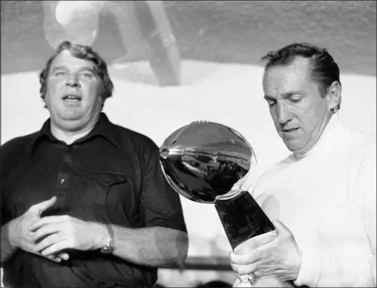  ?? The Associated Press file ?? Raiders coach John Madden, left, and team owner Al Davis admire the Super Bowl trophy after the team defeated the Vikings 32-14 in Super Bowl XI in Pasadena, Calif. The Raiders rushed for a then-super Bowl record of 266 yards.