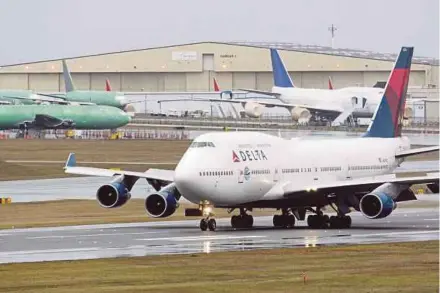  ?? BLOOMBERG PIC ?? A Boeing Co 747-400 airplane operated by Delta Airlines Inc taxis at Paine Field in Everett, Washington. Political obstacles to a deal have eased since a United States spying scandal helped derail a Boeing fighter sale to Brazil in 2013.