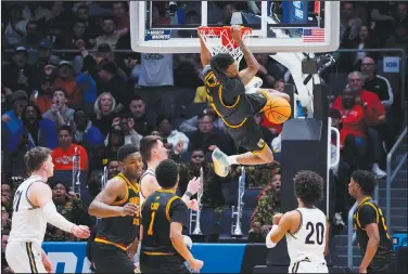  ?? Associated Press ?? Slammed: Grambling State guard Jourdan Smith (11) dunks against Montana State during overtime of a First Four game in the NCAA men's college basketball tournament Wednesday in Dayton, Ohio.