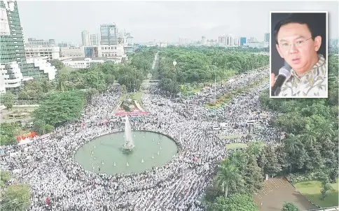  ??  ?? This aerial view shows Indonesian Muslims gathering at Jakarta’s National Monument Park as part of a rally against Purnama (Inset). — AFP photo