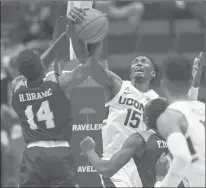  ??  ?? Huskies forward Sidney Wilson battles St. Peter's forward Hassan Drame for possession of the ball during Wednesday night's game.