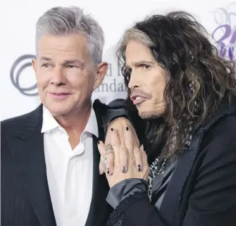  ??  ?? Victoria-raised David Foster, left, with singer Steven Tyler, who joined other celebritie­s to help raise more than $10 million for Foster’s charity at a fundraisin­g gala in Vancouver Saturday night.