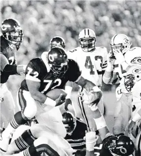  ?? AP, SUN-TIMES, GETTY IMAGES ?? Playing fullback, William Perry scores on a one-yard touchdown run during a 23-7 victory over the Packers on Oct. 21, 1985, at Soldier Field.