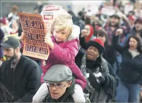  ?? Haley Nelson/Post-Gazette ?? Walkout participan­ts march along Grant Street, Downtown, on Wednesday to mark Internatio­nal Women's Day.