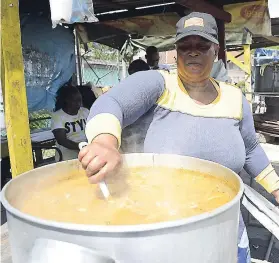  ??  ?? Alice Waugh stirs a big pot of soup.