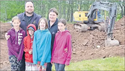  ?? LAURA JEAN GRANT/CAPE BRETON POST ?? Jason and Ann McLean, and their children, from left, Chelsea, Dallas, Angelina and Jocelynn, were on site as the hole was dug for the foundation of their home in Whitney Pier on Tuesday. Crews from McCormick Landscapin­g Ltd. and Carmichael Custom...