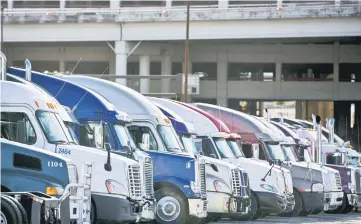  ??  ?? Attendees’ trucks are parked outside of the Dallas Convention Center during the 16th annual Great American Trucking Show in Dallas on Aug. 22, 2014. — WP-Bloomberg photo