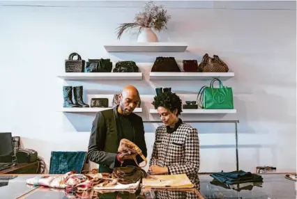  ?? Photos by Michaela Vatcheva/Special to The Chronicle ?? Above: Michael Hillord and Dominique Littleton appraise an early 2000s Fendi baguette at ReLove. “These are the bags I coveted when I first got into fashion,” Hillord said. Below: Stella Tran (right) shops at the Polk Street resale boutique.