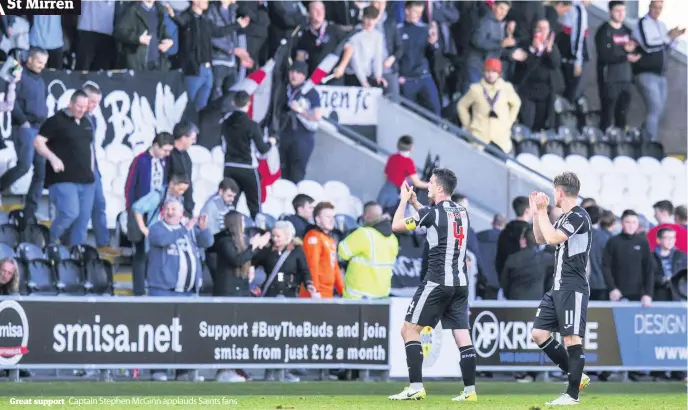  ??  ?? Great support Captain Stephen McGinn applauds Saints fans