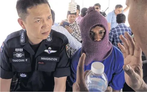  ?? REUTERS ?? Pol Maj-Gen Thatchai Pitaneelab­oot listens as a Rohingya traffickin­g victim leads a police unit to a camp where he was detained in Satun.