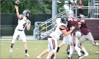  ??  ?? Offensive linemen provide plenty of protection for first-year quarterbac­k Tate Busey, a junior.