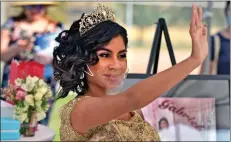  ?? Dan Watson/ The Signal ?? (Above) Honoree Gabriela wears a clear face mask as she waves to passing cars during the Department of Children and Family Services’ quinceañer­a celebratio­n and car parade Saturday at Castaic Sports Complex. (Left) Habee Cruz waves to sister Andrea, one of six honorees taking part in Saturday’s celebratio­n.