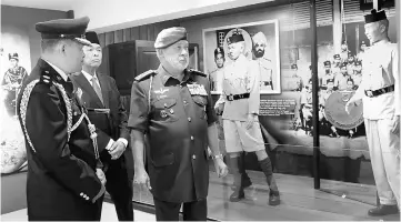  ??  ?? Sultan Ibrahim (right) looking at some of the exhibits. At second left is Ahmad Zahid — Bernama photo