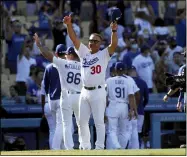  ?? ALEX GALLARDO — THE ASSOCIATED PRESS ?? Los Angeles Dodgers manager Dave Roberts (30) salutes the fans after the Dodgers defeat the Milwaukee Brewers.