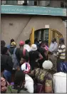  ?? (AP/Tsvangiray­i Mukwazhi) ?? Travelers are seen in a queue outside the passport offices in Harare, Zimbabwe on Wednesday.