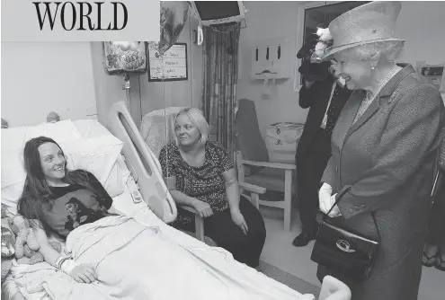  ?? PETER BYRNE / POOL VIA AP ?? Queen Elizabeth speaks to Millie Robson, 15, and her mother, Marie, during a visit Thursday by the British monarch to the Royal Manchester Children’s Hospital to meet victims of Monday’s terror attack in Manchester, and to thank members of staff who...