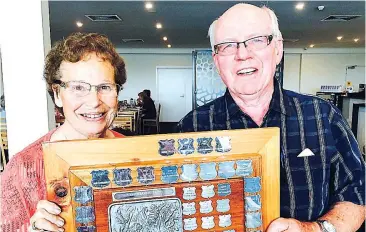  ??  ?? Warragul and District Garden Club president Ralph Slaughter presents the Annual Competitio­n Shield to threepeat winner Aileen White.