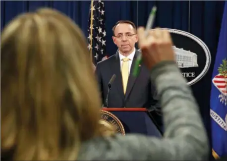  ?? AP PHOTO/JACQUELYN MARTIN ?? A reporter raises her hands to ask a question of Deputy Attorney General Rod Rosenstein, after he announced that the office of special counsel Robert Mueller says a grand jury has charged 13 Russian nationals and several Russian entities, Friday, Feb....