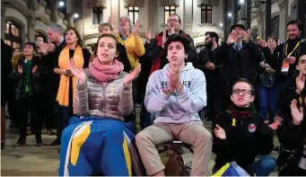  ??  ?? ERC – ‘Esquerra Republican­a de Catalunya’ (or Republican Left of Catalonia) – supporters watch polls results of the Catalan regional election in Barcelona on Thursday