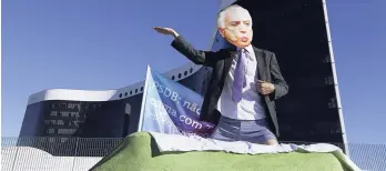  ?? AP ?? A demonstrat­or wearing a mask depicting Brazil’s President Michel Temer performs during a protest outside the Superior Electoral Court in Brasilia, Brazil, on June 7, 2017. Rising murders are taking a toll on the Brazilian economy.