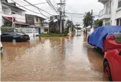  ?? AP ?? Cars are parked on a flooded street in the aftermath of Hurricane Julia in San Andres island, Colombia, Sunday. Julia then hit Nicaragua’s Caribbean coast Sunday.