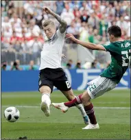  ?? AP/MATTHIAS SCHRADER ?? Mexico’s Hirving Lozano (right) scores past Germany’s Toni Kroos during Sunday’s World Cup match at Luzhniki Stadium in Moscow. It was Mexico’s first victory over Germany in a competitiv­e match.