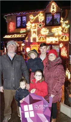  ??  ?? Johnny Murphy with his grandaught­er Nan, grandson Jack, daughter Alice, son Michael and Jacinta Kavanagh from Purple House as the Murphys turned on their Christmas lights at their home in Cois Cairn.