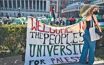  ?? ?? A sign is displayed in front of the tents erected at the Pro-Palestine protest encampment at the Columbia University campus in New York; Students from Massachuse­tts of Technology, Harvard University and others protest (top right) at MIT’s Kresge Lawn and Pro-Palestinia­n demonstrat­ors (right) call for Yale to disinvest from military weapons manufactur­ers, on Monday.