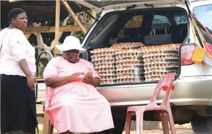  ??  ?? This unidentifi­ed woman sells eggs and bags from the boot of a vehicle in Harare. Many vendors play hide and seek with municipal police. — (Picture by Memory Mangombe)