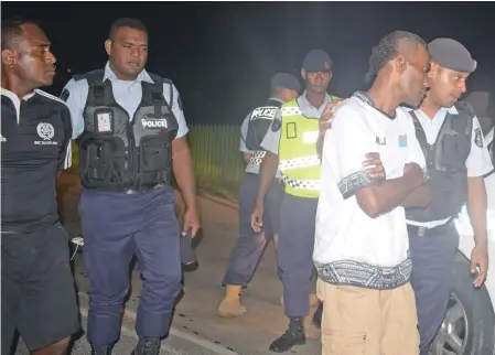  ?? Photo: Ronald Kumar ?? Police at Reservoir Road checkpoint in Suva detained three people, who were found allegedly walking around during the curfew hours on April 1, 2020.