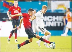  ?? (AP) ?? Manchester United midfielder Ander Herrera (front left), takes control of the ball from Real Madrid forward Martin Odegaard during the second half of an Internatio­nal Champions Cup tournament soccer match on July 31, 2018, in Miami Gardens,...