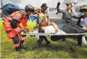  ?? MOISES CASTILLO AP ?? A woman is rescued Saturday from the area where scores are believed buried by a mudslide in Guatemala.