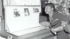  ?? CHICAGO SUN-TIMES VIA AP ?? In this 1955 file photo, Mamie Till-mobley, mother of Emmett Till, pauses at her son's casket at a Chicago funeral home.