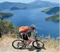  ??  ?? Lisa Morrison from Nelson rides on the Queen Charlotte Track, in the Marlboroug­h Sounds, which will link to a new trail to Christchur­ch.