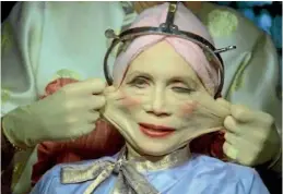  ??  ?? Or is this the future? Katherine Helmond experience­s radical plastic surgery in the film Brazil.