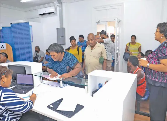  ??  ?? Members of the public being served at the new Voter Service Centre in Suva city.