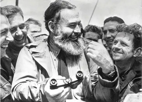  ?? Central Press / Tribune News Service ?? Ernest Hemingway, in his capacity as war correspond­ent, traveled with U.S. soldiers on their way to Normandy for the D-Day landing in 1944.