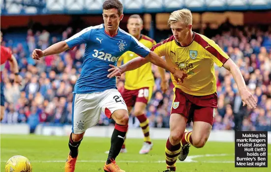  ??  ?? Making his mark: Rangers trialist Jason Holt (left)
holds off Burnley’s Ben Mee last night