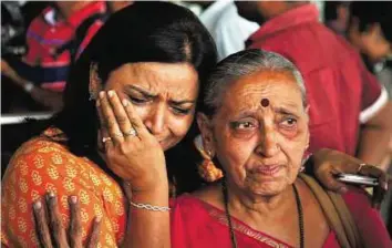  ?? AP ?? Reunited A woman cries after her relative (right) who was on pilgrimage in Nepal during Saturday’s earthquake, returned at the airport in Ahmadabad on Monday.