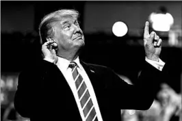  ?? ALEX BRANDON/AP ?? President Donald Trump arrives at a rally Tuesday night at the Phoenix Convention Center, where thousands of supporters greeted the president with chants of “USA! USA! USA!”