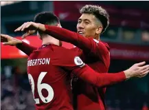  ?? ?? EARLY OPENER: Firmino (right) celebrates with Robertson after the Brazilian netted from the Scotland skipper’s cross