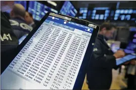  ?? RICHARD DREW — THE ASSOCAITED PRESS ?? A trader’s handheld device shows his numerous sell orders on the floor of the New York Stock Exchange. The Dow Jones Industrial Average plummeted 7.79%.