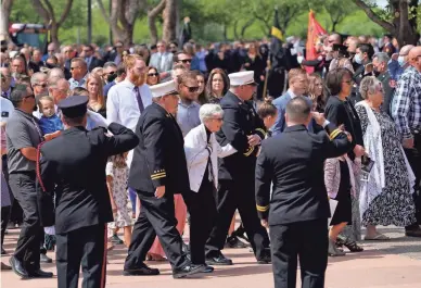  ??  ?? Family and friends follow the casket during the memorial service for Buckeye Fire Chief Bob Costello at Christ’s Church of the Valley in Peoria on Thursday. Costello had served as fire chief since 2008.