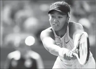  ?? The Cincinnati Enquirer file photo/AP ?? Naomi Osaka returns a shot against Sofia Kenin on Aug. 16 during a quarterfin­al match of the Western & Southern Open tennis tournament in Mason, Ohio.