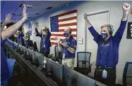  ?? Bill Ingalls / NASA via New York Times ?? Members of the Perseveran­ce rover team rejoice at NASA’s Jet Propulsion Laboratory in Pasadena, Calif.