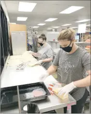  ?? COURTESY PHOTO ?? Right: Anna Gonzalez and Lorene Jewett make meals for Lincoln students home for the summer. Left: Abby
Goldman and Michael Brown put together meals Aramark employees, school employees, bus drivers and volunteers have worked together to meet the hunger needs of their students.