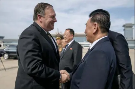  ?? ANDREW HARNIK — THE ASSOCIATED PRESS ?? U.S. Secretary of State Mike Pompeo, left, says goodbye to Kim Yong Chol, right, a North Korean senior ruling party official and former intelligen­ce chief, before boarding his plane at Sunan Internatio­nal Airport in Pyongyang, North Korea, Saturday to travel to Japan.