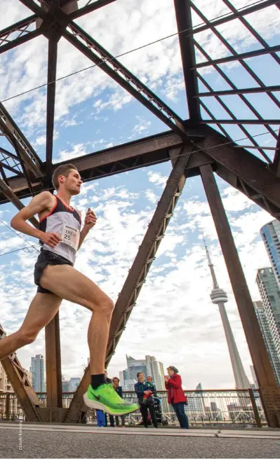  ??  ?? LEF T Trevor Hofbauer on course at the Scotiabank Toronto Waterfront Marathon wearing the Nike ZoomX Vaporfly NEXT%