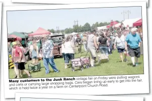  ??  ?? pulling wagons Ranch vintage fair on Friday wereMany customers to the Junk to get into the fair, bags. Cars began lining up early and carts or carrying large shopping on Centerpoin­t Church Road. which is held twice a year on a farm