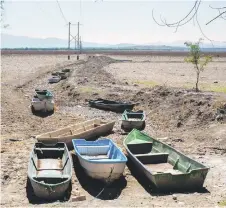  ?? ?? Small boats are seen on dried-up land where there used to be water in Lake Cuitzeo, at the Mariano Escobedo community, Michoacan State, Mexico.